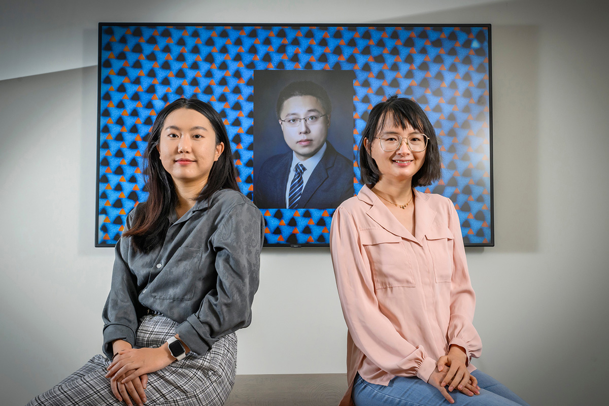 Jiahui Li, left, Shan Zhou and professor Qian Chen show off an electron micrograph image of their new pinwheel lattice structure developed to help engineers build new materials with unique optical, magnetic, electronic and catalytic properties.